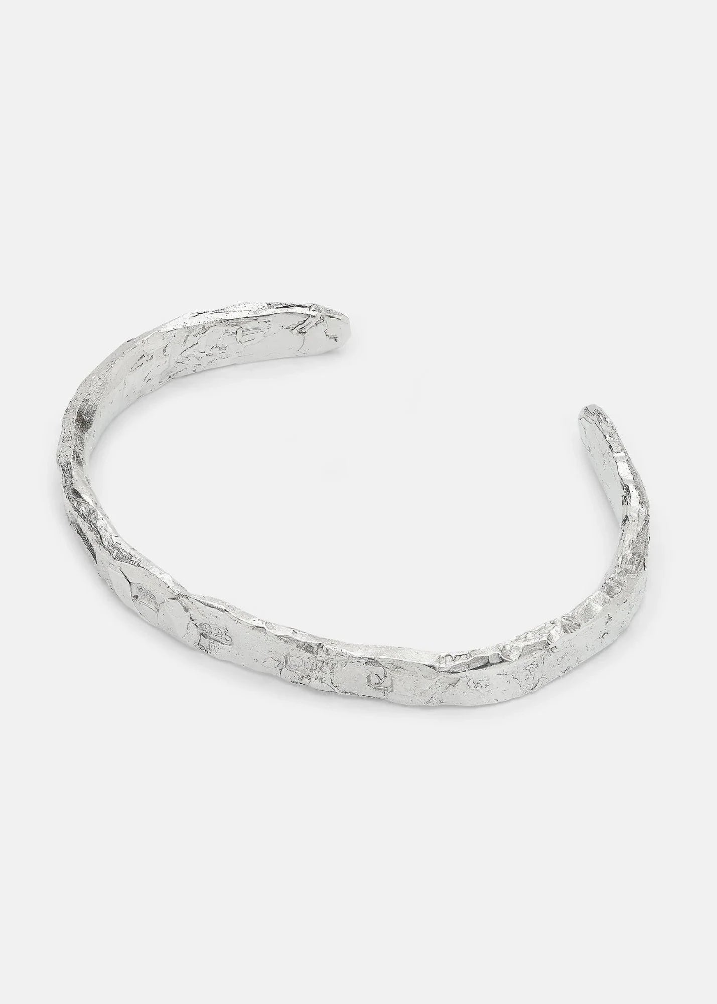 Silver textured bangle on a light gray background