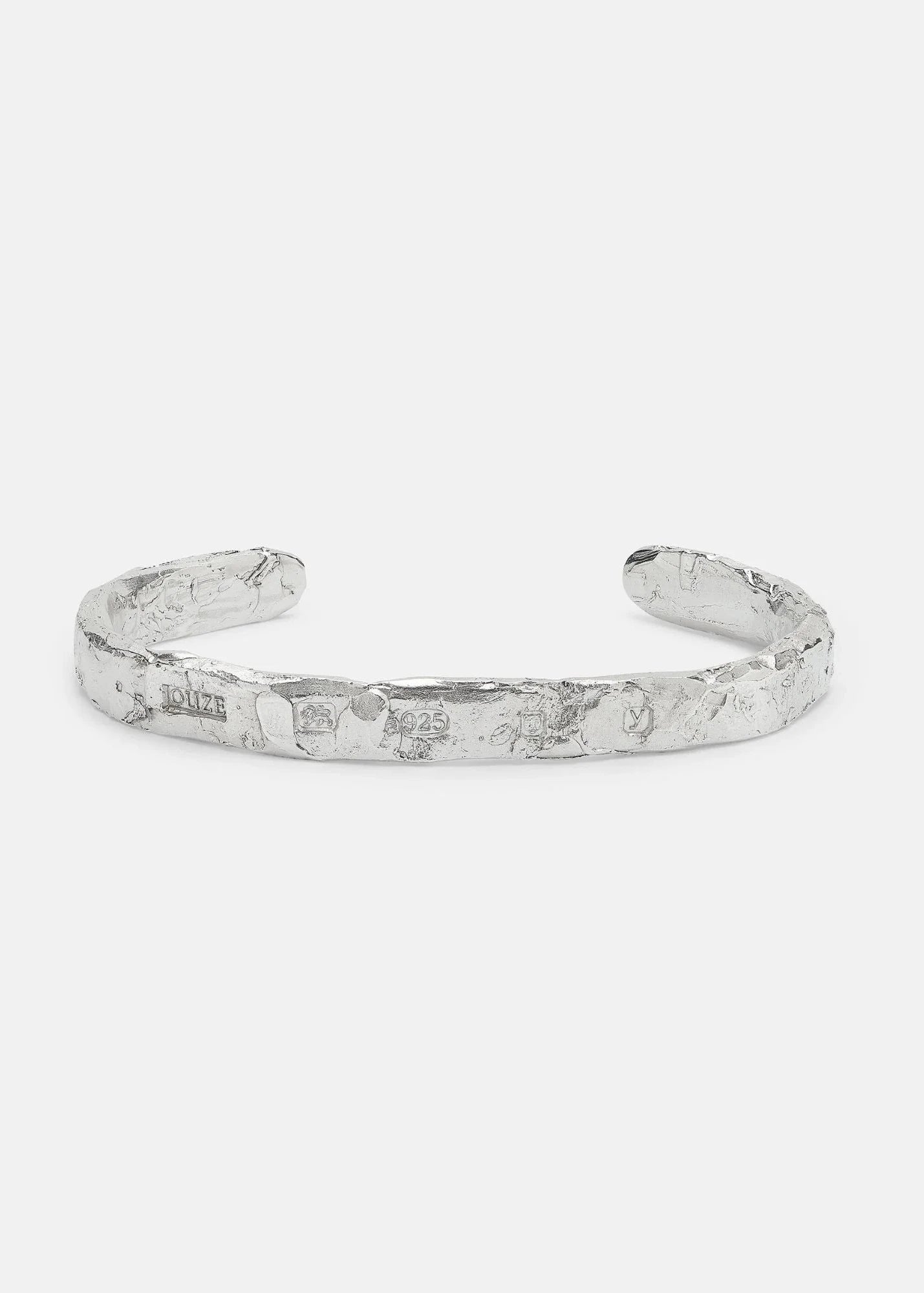 Silver bracelet on a light gray background