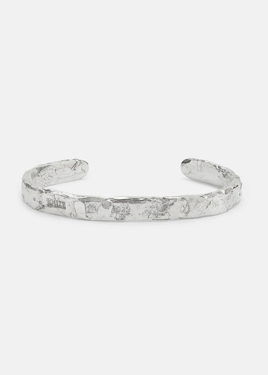 Silver bracelet on a light gray background