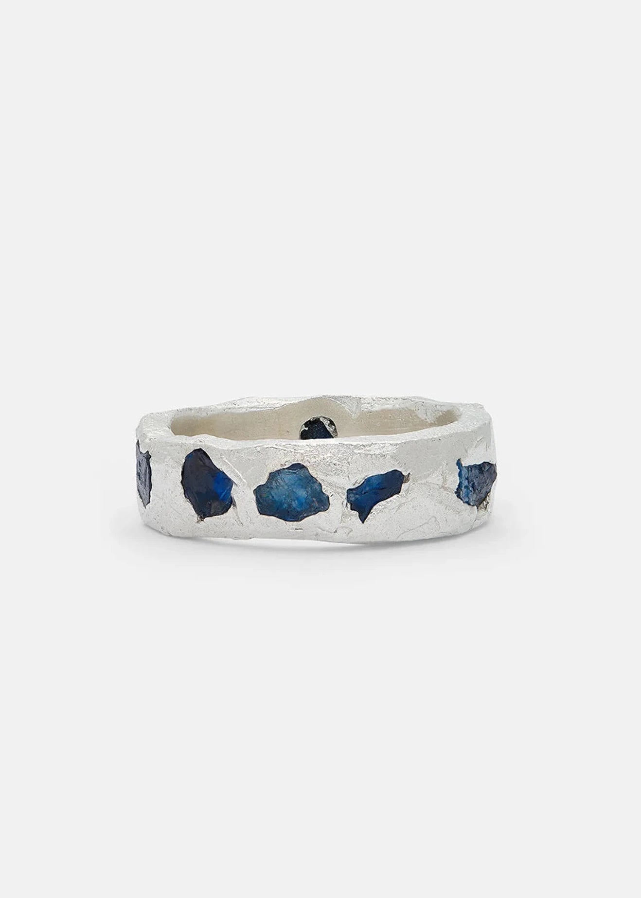 Silver ring with blue gemstones on a white background