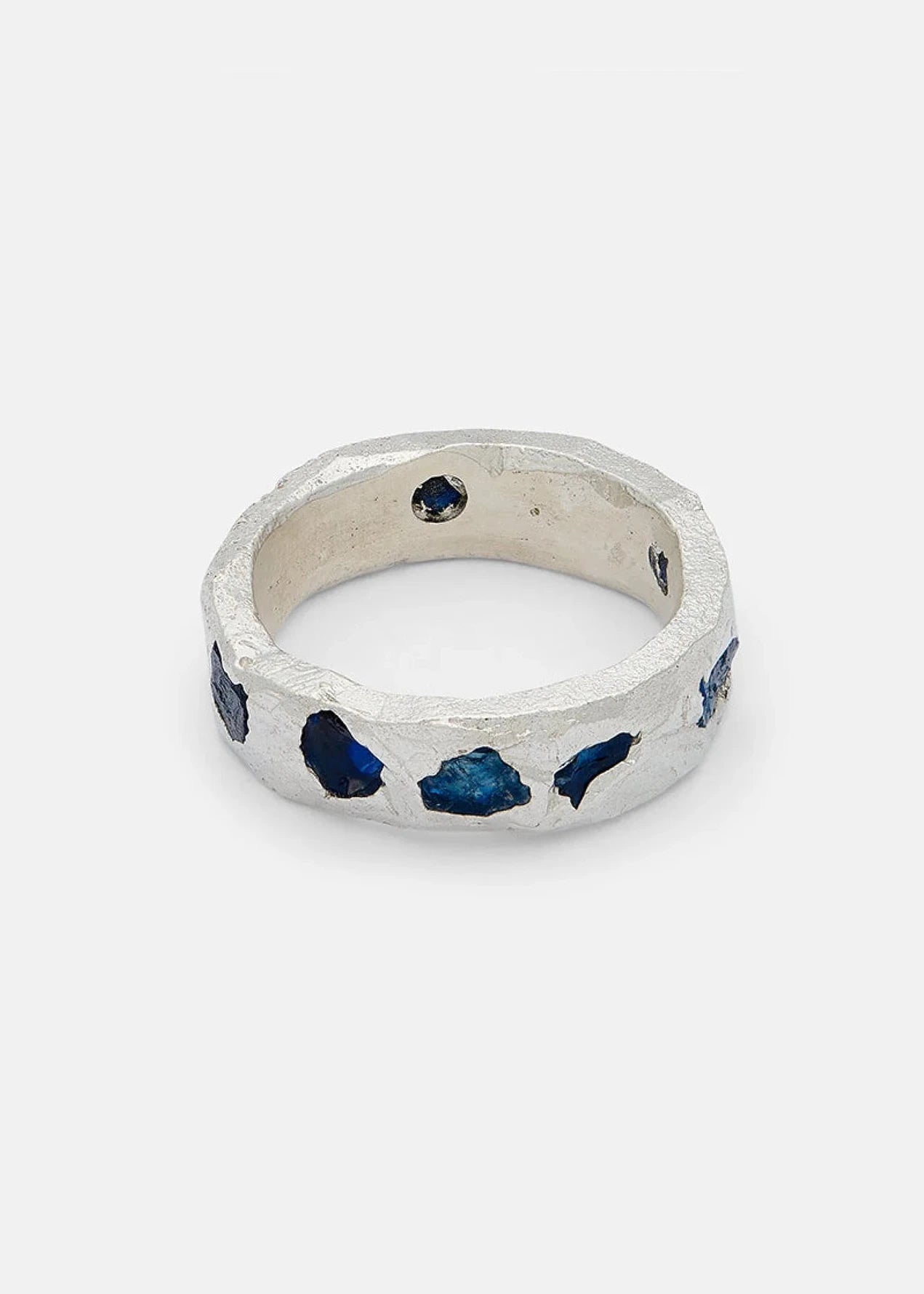 Silver ring with blue stones on a white background