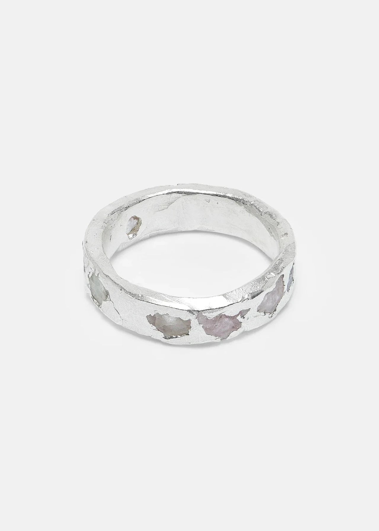 Silver ring with a textured design on a light gray background